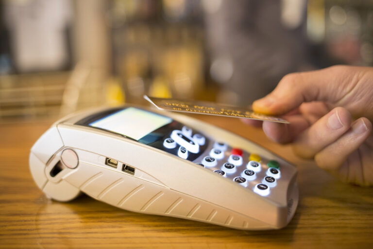 Man paying with NFC technology on credit card, restaurant, shop